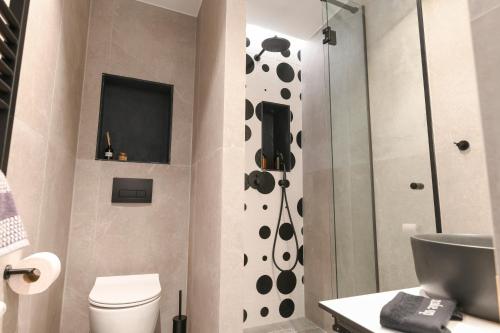 a bathroom with a shower and a toilet at OMIKRON luxury living in Thessaloniki