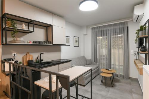 a kitchen and living room with a couch and a table at OMIKRON luxury living in Thessaloniki