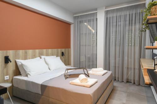 a bedroom with a bed with towels on it at OMIKRON luxury living in Thessaloniki