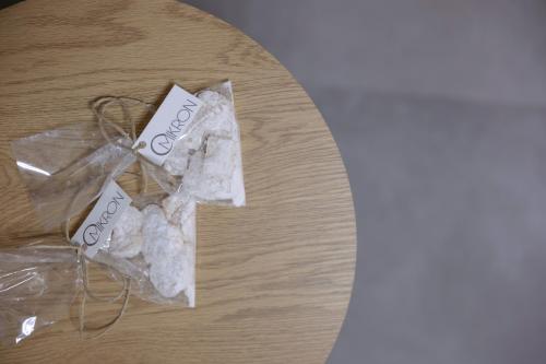 a plastic bag of cookies on a wooden table at OMIKRON luxury living in Thessaloniki