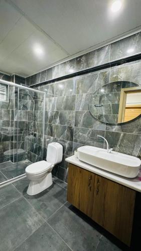 a bathroom with a toilet and a sink and a shower at Akapella in Pamukkale