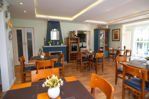 a dining room with wooden tables and chairs at Pousada Orquidea da Serra in Petrópolis