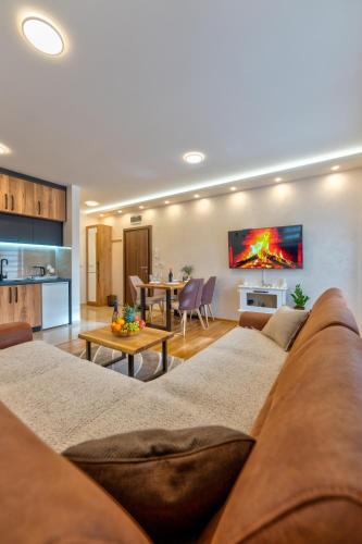 a living room with a couch and a table at Apartman Andjela12 Zlatibor in Ocka Gora