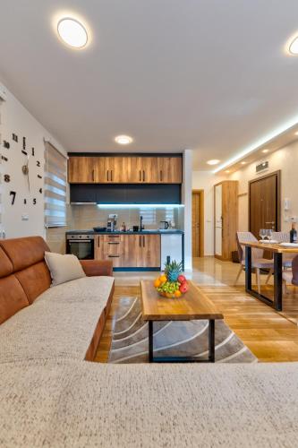 a large living room with a couch and a table at Apartman Andjela12 Zlatibor in Ocka Gora