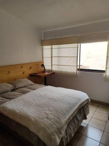 a bedroom with a large bed and a window at Cómoda habitación independiente Miraflores in Lima