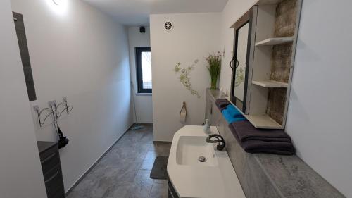 a white bathroom with a tub and a sink at Ferienwohnung Lehmann 2 in Wolfenbüttel