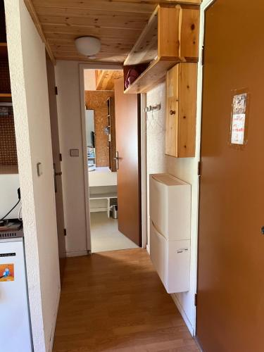 - un couloir d'une cuisine avec un réfrigérateur dans l'établissement Studio 2 personnes, à Val-des-Prés