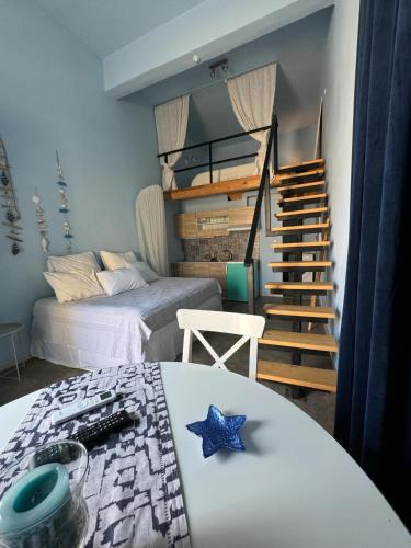 a bedroom with two beds and a staircase with a star on a table at Cozy Jimmys Studios Ermioni in Ermioni