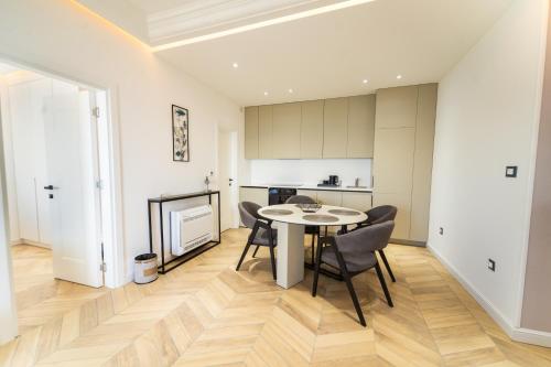 a kitchen and dining room with a table and chairs at Exclusive Hotel in Budva
