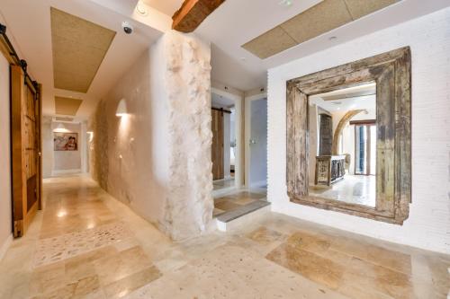 a hallway with white walls and a large mirror at Maison Salva - Hotel Boutique in Altea