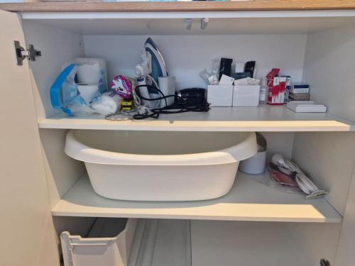 a shelf in a closet filled with lots of items at Loft acogedor in Seville
