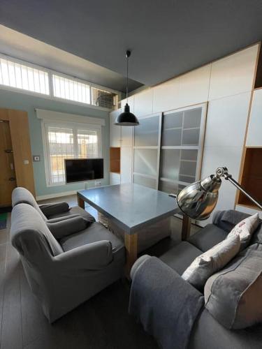 a living room with a table and two couches at Loft acogedor in Seville