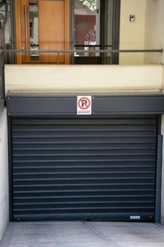a garage door with a no parking sign on it at Υπέροχο διαμέρισμα με πάρκινγκ in Larisa