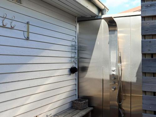 a metal door on the side of a building at 9 person holiday home in Skummeslövsstrand in Skummeslövsstrand