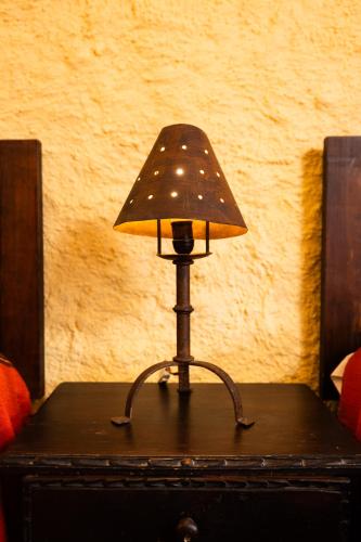 a small lamp sitting on top of a chest at Hotel La Sin Ventura in Antigua Guatemala
