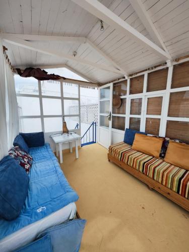 a large room with a couch and a table at Moroccan Riad With Panoramic Sea View in Essaouira