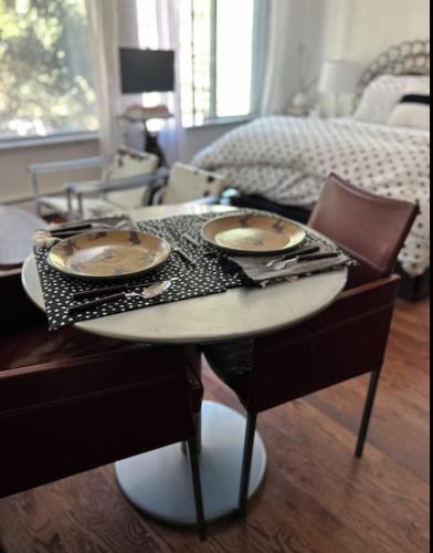 a table with plates on top of it in a bedroom at Perfect Inside Downtown Aspen Location! Romantic 1300 ft, 4 Blocks or 396 m, to AJAX or Aspen Mountain in Aspen