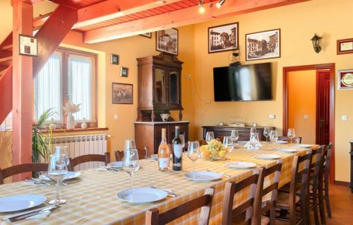 a large dining room with a long table with chairs at Beautiful Villa Parenzana with pool in Vizinada in Vižinada