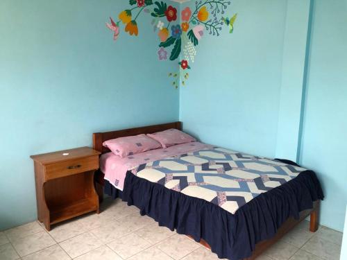 a bedroom with a bed and a wooden desk at Zumag Sisa in Tena