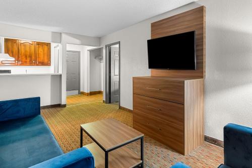 a living room with a couch and a flat screen tv at Quality Inn in Cornelia