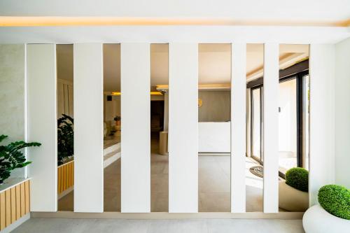 a living room with white columns at Exclusive Hotel in Budva