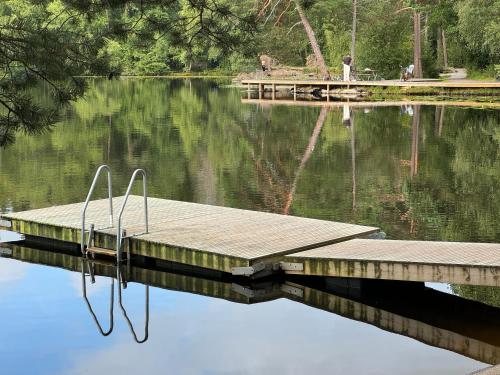 a dock in the middle of a body of water at Villa Trollbäcken med bastu, värmegolv, öppen spis in Tyresö