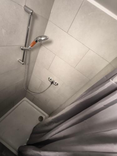 a shower stall in a bathroom with a toilet at Maison entière privée in Charleroi