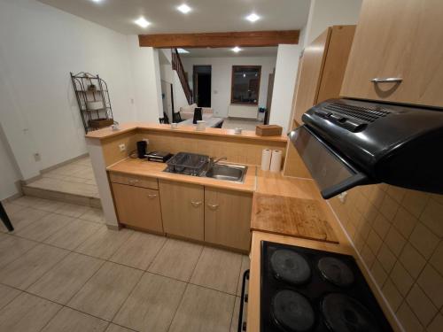 a kitchen with a stove and a counter top at Maison entière privée in Charleroi