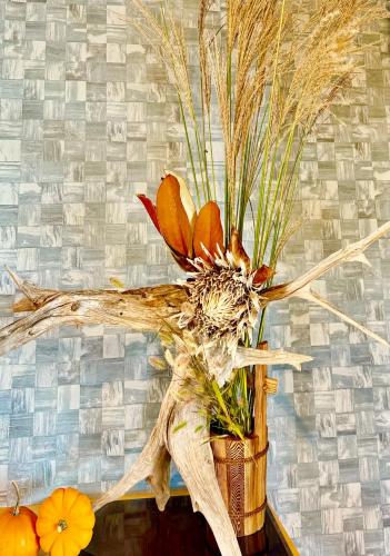 a vase filled with flowers and grass at Private Villa ietona in Fujikawaguchiko