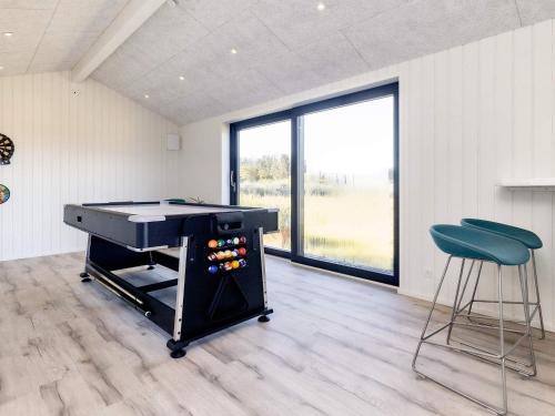a room with a ping pong table and two stools at 5 star holiday home in Hirtshals-By Traum in Hirtshals