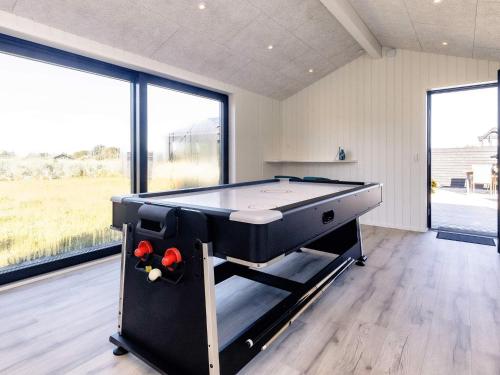 a pool table in a room with large windows at 5 star holiday home in Hirtshals-By Traum in Hirtshals