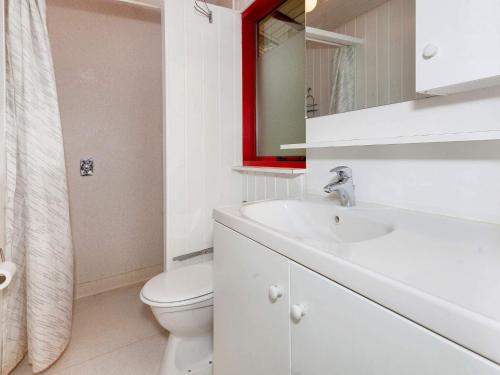 a bathroom with a sink and a toilet and a mirror at 6 person holiday home in Læsø in Læsø