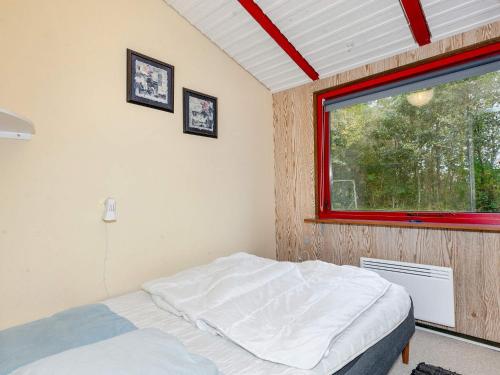 a bedroom with a bed and a window at 6 person holiday home in Læsø in Læsø