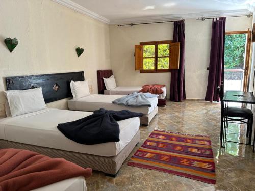 Postel nebo postele na pokoji v ubytování Kasbah Imoula
