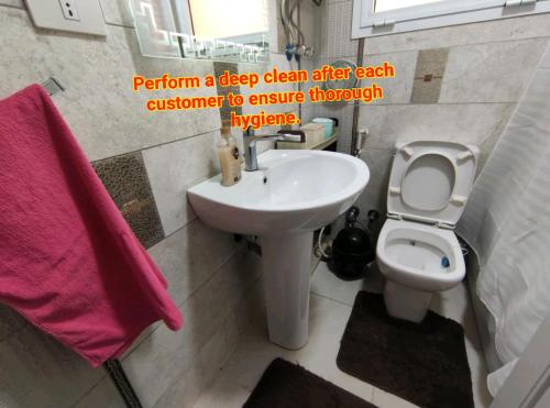 a bathroom with a sink and a toilet at Madinty amazing view 2 rooms fully air-conditioned apartment at Madinty city for families only مدينتي in Madinaty