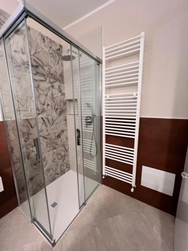a shower with a glass door in a bathroom at Emilia381 Suite in Anzola dell'Emilia