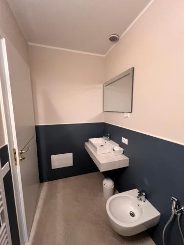 a bathroom with a sink and a toilet at Emilia381 Suite in Anzola dell'Emilia