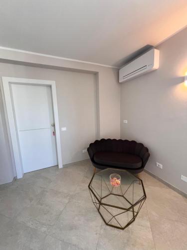 a living room with a black couch and a door at Emilia381 Suite in Anzola dell'Emilia