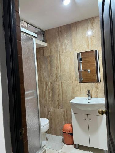 a bathroom with a sink and a toilet at Palmeras house in Ica
