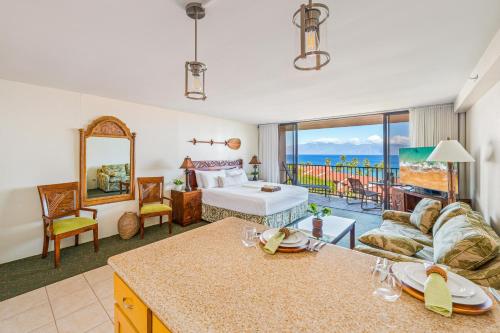 a living room with a bed and a couch at Kaanapali Shores 940 · KS 940 Top Floor Studio w Ocean Views AC in Lahaina