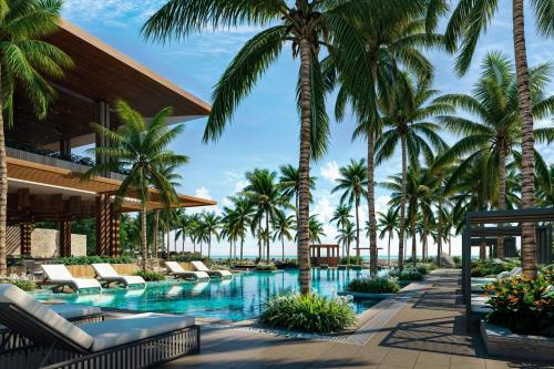 una piscina en el resort con palmeras en Donoma Las Terrenas Beach Hotel & Spa, Autograph Collection, en Las Terrenas