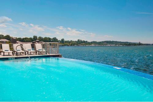 a swimming pool on the edge of a body of water at Courtyard by Marriott Erie Bayfront in Erie