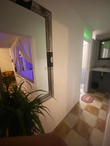 a mirror hanging on a wall in a room at Nizar Surf Morocco in Taghazout