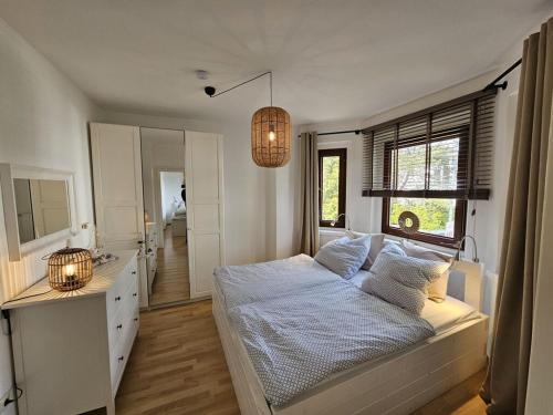 a bedroom with a bed and a sink and a mirror at Raphael - "Marilyn Monroe" in Timmendorfer Strand