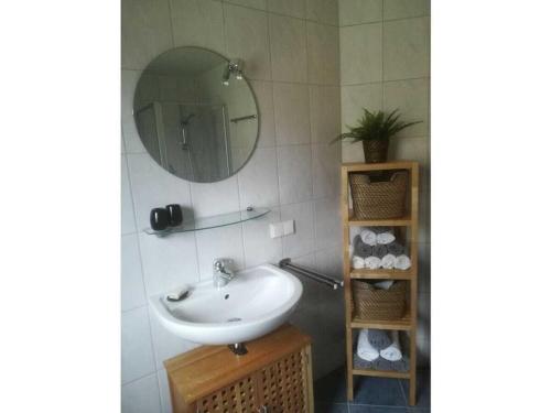 a bathroom with a sink and a mirror at Tromm - Blick Comfortable holiday residence in Rimbach