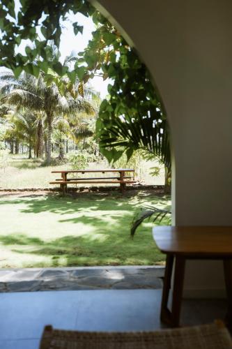 a view of a park with a bench in the grass at Rumah Markisa Batukaras in Batukaras