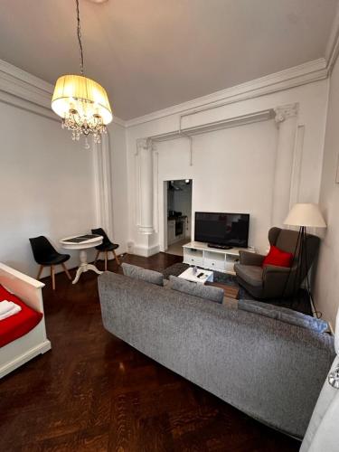 a living room with a large couch and a table at Cismigiu Apartments in Bucharest