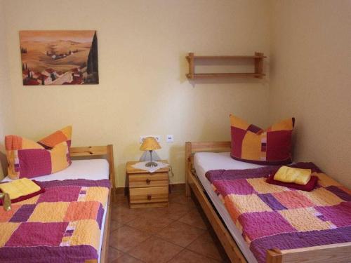 a bedroom with two beds and a lamp on a table at Holiday house with 1 bedroom in Sewekow