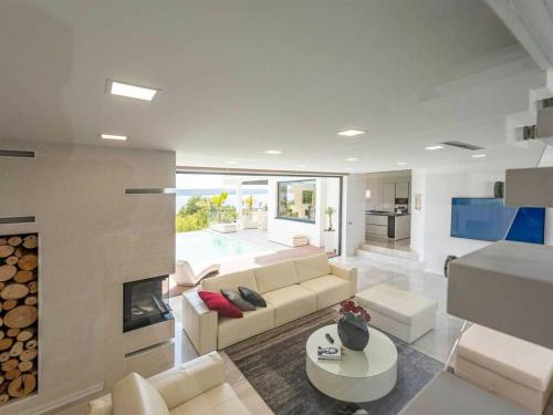 a living room with a couch and a fireplace at Luxury Villa Michele with heated pool in Jasenice