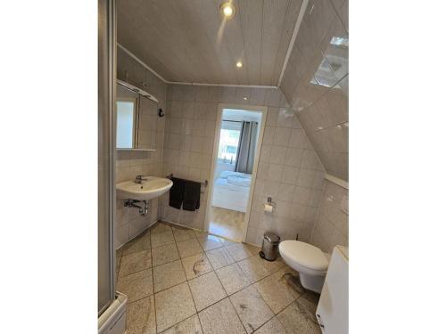 a bathroom with a toilet and a sink at Raphael - "Roger Moore" in Timmendorfer Strand